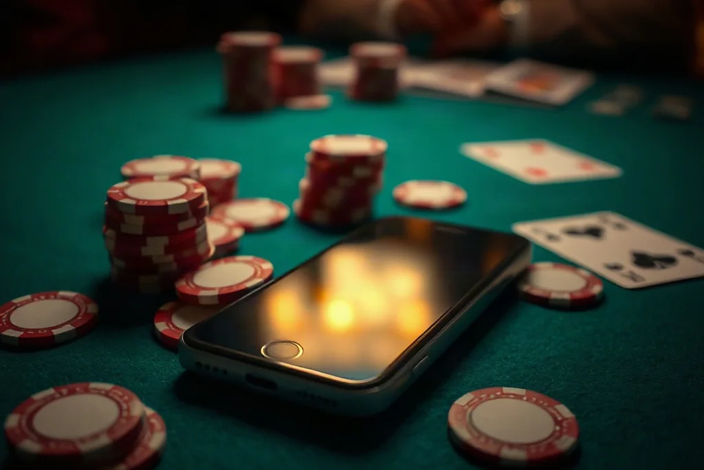 Smartphone held in one hand showing a live betting interface during a football match